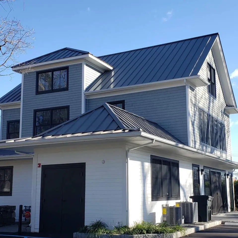 a white house with a black garage